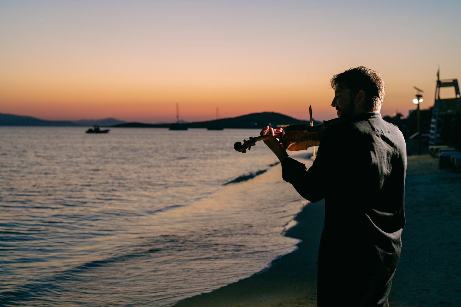 Live violin sunset ritual at Santana Naxos events — the signature golden hour wine Naxos moment